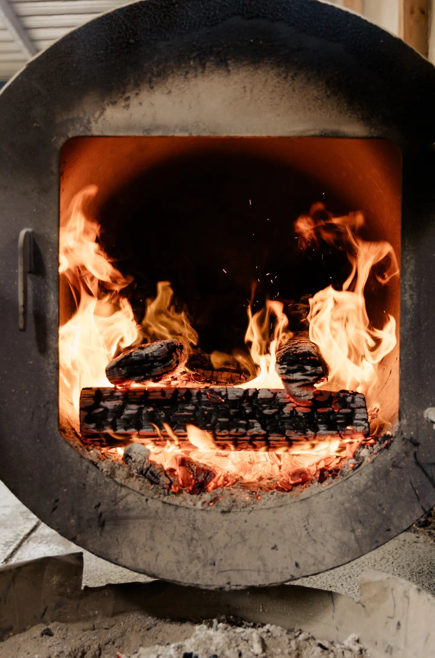 Split logs burning in an open firebox