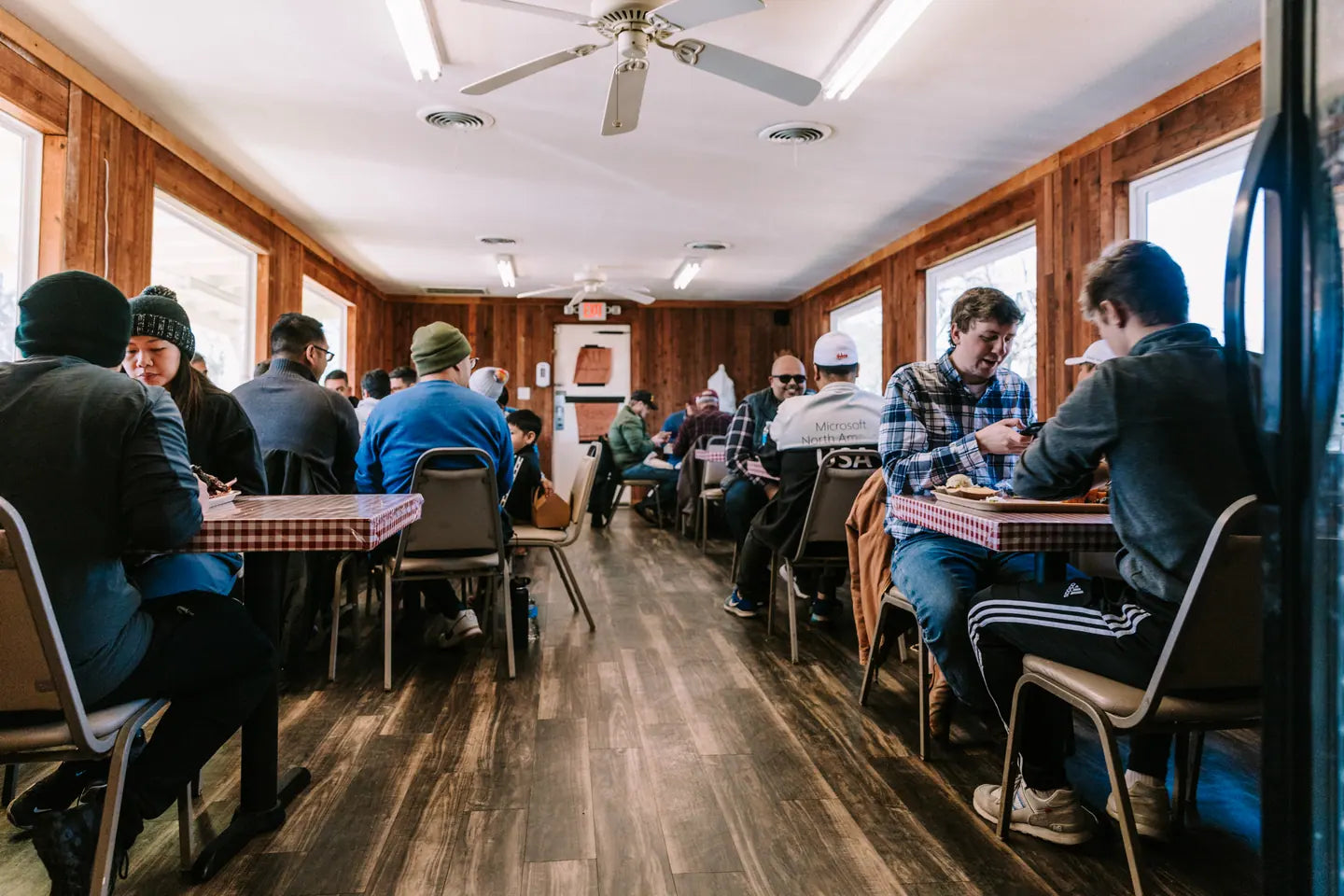 The full dining room during service, every table taken