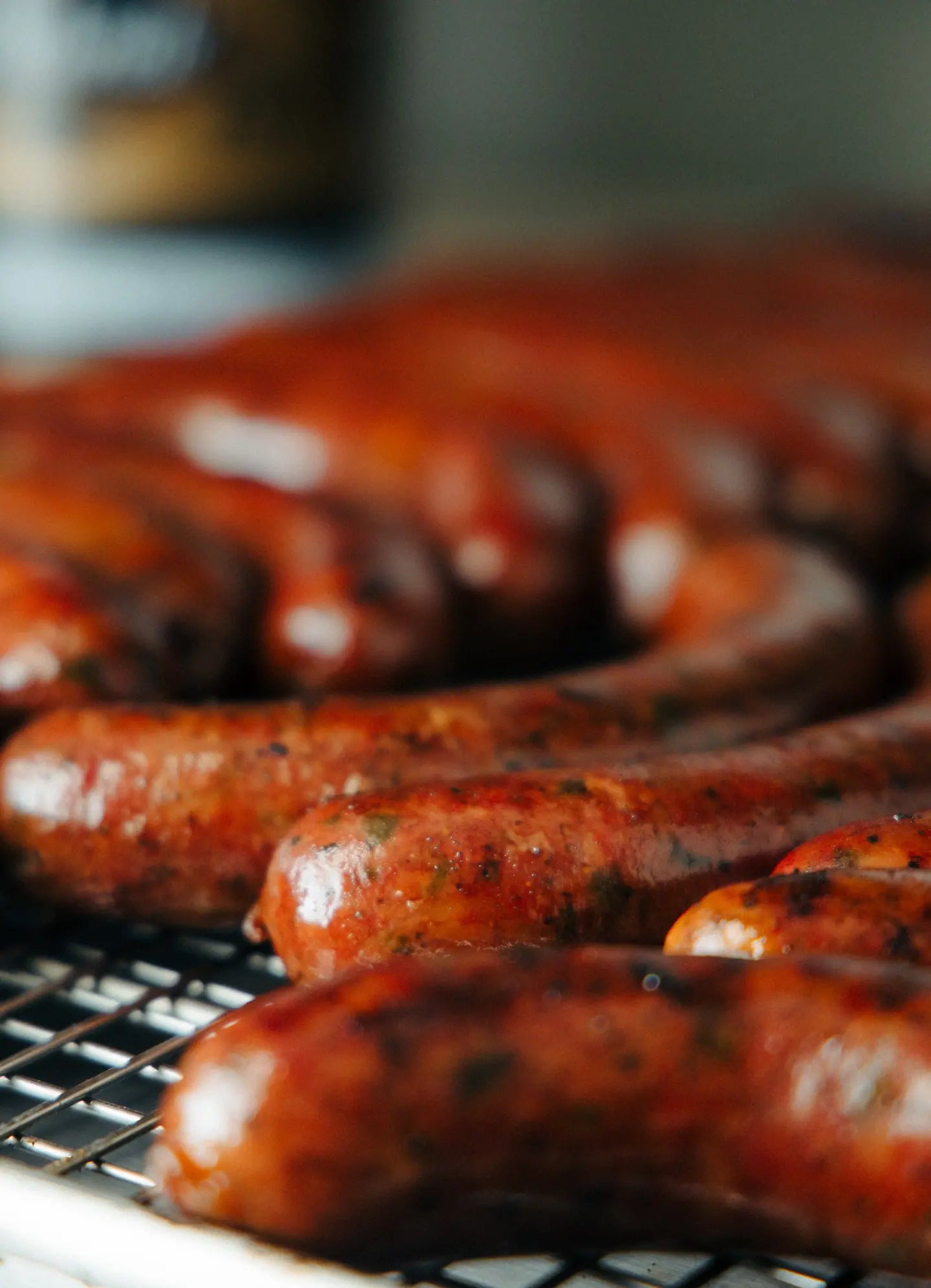 Glazed sausage links on the smoker rack